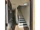 Inviting entryway featuring a staircase with black and white risers and wood floors at 217 N Myrtle St. # 1, Myrtle Beach, SC 29577