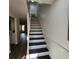 Bright staircase featuring white risers and contrasting black treads, leading to upper level at 217 N Myrtle St. # 1, Myrtle Beach, SC 29577