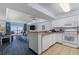 Open-concept kitchen with granite countertops, white cabinetry, and views into the living and dining areas at 2201 S Ocean Blvd. # 1707, Myrtle Beach, SC 29577