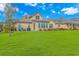 Lovely backyard featuring a well-manicured lawn and inviting patio area with blue furniture and lush green spaces at 2212 Via Palma Dr., North Myrtle Beach, SC 29582