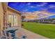 Picturesque backyard patio with charming blue furniture showcasing the lush green lawn and scenic golf course views at 2212 Via Palma Dr., North Myrtle Beach, SC 29582