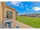Inviting backyard patio with charming blue furniture overlooking the lush green lawn and scenic golf course views at 2212 Via Palma Dr., North Myrtle Beach, SC 29582