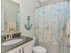 Cozy bathroom with anchor decoration, vanity, and themed shower curtain at 2212 Via Palma Dr., North Myrtle Beach, SC 29582