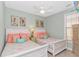 Charming bedroom featuring two twin beds, coastal decor, and a ceiling fan, creating a relaxing beachside ambiance at 2212 Via Palma Dr., North Myrtle Beach, SC 29582