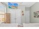 Bright bedroom showcasing a TV, closet, and coastal-themed decor, offering comfort and style at 2212 Via Palma Dr., North Myrtle Beach, SC 29582