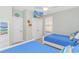 Bright bedroom showcasing a TV, closet, and coastal-themed decor, offering comfort and style at 2212 Via Palma Dr., North Myrtle Beach, SC 29582