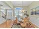 Bright dining room with large window, chandelier, and elegant wainscoting at 2212 Via Palma Dr., North Myrtle Beach, SC 29582