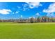 Expansive view of the well-maintained golf course lined with beautiful homes and lush trees under a blue sky at 2212 Via Palma Dr., North Myrtle Beach, SC 29582