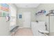Functional laundry room with bench, washer, dryer, and ample storage, designed for convenience at 2212 Via Palma Dr., North Myrtle Beach, SC 29582