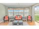 Cozy living room with comfortable wicker furniture, large windows, and a sliding door to the outside at 2212 Via Palma Dr., North Myrtle Beach, SC 29582