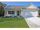 Charming single-story home with a well-manicured lawn and an attached two-car garage at 2315 Withers St., Georgetown, SC 29440