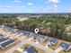 An aerial view showcases the home's location within a community near a wooded area at 236 Craigflower Ct., Longs, SC 29568