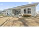 Backyard featuring a covered patio with play set, garden box, and lush green grass at 236 Craigflower Ct., Longs, SC 29568
