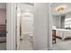 Bathroom featuring a shower-tub combo, white fixtures, and views to other rooms at 236 Craigflower Ct., Longs, SC 29568
