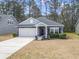 Beautiful single-Gathering home boasts stone accents, a two-car garage, and a well-manicured lawn at 236 Craigflower Ct., Longs, SC 29568
