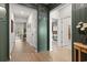Hallway with wood floors, decorative wallpaper, and access to various rooms at 236 Craigflower Ct., Longs, SC 29568