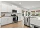 Well-lit kitchen featuring stainless steel appliances, bright white cabinets and ample counter space at 236 Craigflower Ct., Longs, SC 29568