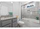 Well-lit bathroom with a granite countertop, stylish gray cabinets, and a tiled shower-over-tub at 2406 Seabreeze Pl., Myrtle Beach, SC 29577