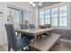 Inviting dining area with a wooden table, upholstered chairs, bench seating, and natural light at 2406 Seabreeze Pl., Myrtle Beach, SC 29577