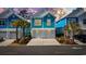 Charming teal two-story home with a double garage and palm trees at 2406 Seabreeze Pl., Myrtle Beach, SC 29577