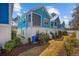 Charming coastal home exterior featuring vibrant blue siding, white trim, and well-kept landscaping at 2406 Seabreeze Pl., Myrtle Beach, SC 29577