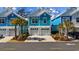 Charming teal two-story home with a double garage and palm trees at 2406 Seabreeze Pl., Myrtle Beach, SC 29577