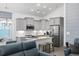 Stylish open kitchen with gray cabinets, stainless appliances, a kitchen island, and living room access at 2406 Seabreeze Pl., Myrtle Beach, SC 29577