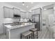 Bright kitchen featuring granite countertops, white cabinets, stainless appliances, and an eat-in breakfast bar at 2406 Seabreeze Pl., Myrtle Beach, SC 29577