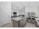 Open-concept living area with kitchen island, stainless steel appliances, dining area, and comfortable living room at 2406 Seabreeze Pl., Myrtle Beach, SC 29577