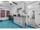 Unique kitchenette with white cabinets, granite countertop, and a beverage cooler, adjacent to the living space at 2406 Seabreeze Pl., Myrtle Beach, SC 29577