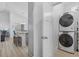 Well-equipped laundry area with stacked washer and dryer units, plus a convenient view into the kitchen at 2406 Seabreeze Pl., Myrtle Beach, SC 29577