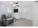 Bright living room features a blue armchair and wood flooring at 2406 Seabreeze Pl., Myrtle Beach, SC 29577