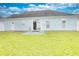 Backyard with a patio area and exterior view of home with sliding glass doors at 264 La Patos Dr., Myrtle Beach, SC 29588