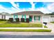 Charming single-story home featuring a well-manicured lawn and colorful blue shutters at 264 La Patos Dr., Myrtle Beach, SC 29588