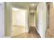 Hallway with wood floors leading to a bedroom with a ceiling fan at 264 La Patos Dr., Myrtle Beach, SC 29588