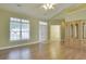 Living room with hardwood floors, a front door, and large windows at 264 La Patos Dr., Myrtle Beach, SC 29588