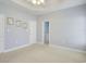 Large main bedroom featuring tray ceilings, plush carpet and an ensuite bathroom at 264 La Patos Dr., Myrtle Beach, SC 29588