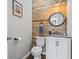 Stylish powder room featuring reclaimed wood accent wall and modern fixtures at 2668 Corn Pile Rd., Myrtle Beach, SC 29588