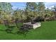 A backyard fire pit area features two chairs, perfect for relaxing and enjoying the outdoors with friends and Gathering at 2668 Corn Pile Rd., Myrtle Beach, SC 29588