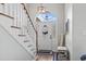 Bright foyer with a white staircase, arched window above the front door, and hardwood floors at 2668 Corn Pile Rd., Myrtle Beach, SC 29588