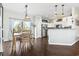 Open kitchen layout with white cabinets, stainless steel appliances, hardwood flooring, and a dining area at 2668 Corn Pile Rd., Myrtle Beach, SC 29588