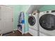 Well-organized laundry room features modern white washer and dryer and a convenient storage rack by the entry door at 2668 Corn Pile Rd., Myrtle Beach, SC 29588