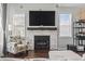 Comfortable living room with a stone fireplace, mounted TV, and a cozy armchair at 2668 Corn Pile Rd., Myrtle Beach, SC 29588