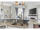Open floor plan view with a stone fireplace, large windows, stainless sink, and pendant lighting at 2668 Corn Pile Rd., Myrtle Beach, SC 29588