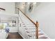Elegant staircase with white railings, wood steps, and views into the kitchen at 2668 Corn Pile Rd., Myrtle Beach, SC 29588
