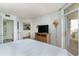 Comfortable bedroom with a balcony door, TV, and connected bathroom and kitchen at 2701 S Ocean Blvd. # 202, North Myrtle Beach, SC 29582