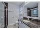 Bathroom featuring vanity with granite countertop, shower, and natural light from a window at 2705 Mercer Dr. # 2705, Conway, SC 29526