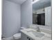 Light blue bathroom with white marble vanity and shower with black tiled walls and silver fixtures at 2705 Mercer Dr. # 2705, Conway, SC 29526