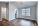 Bedroom with wood-look flooring, ceiling fan, window, and access to an ensuite bathroom at 2705 Mercer Dr. # 2705, Conway, SC 29526