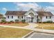 White clubhouse with black gate, landscape beds, and walkway at 2705 Mercer Dr. # 2705, Conway, SC 29526